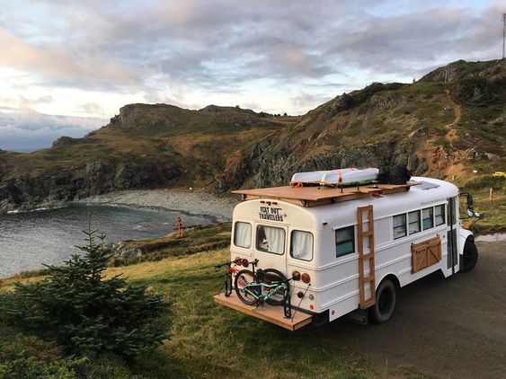 A Skoolie parked by a lake